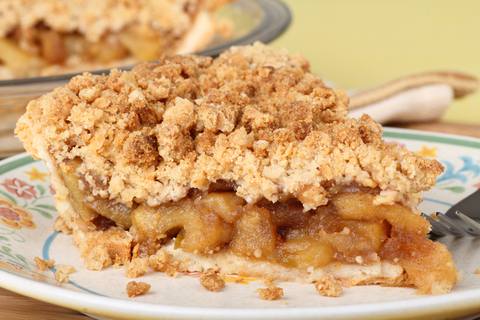 A slice of apple pie on a plate.
